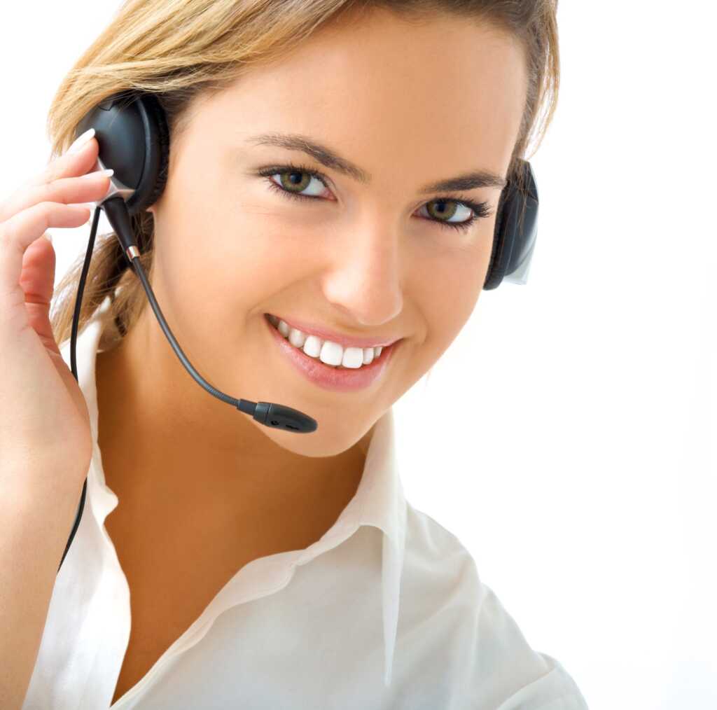 Smiling female customer service agent wearing a headset and microphone, ready to assist.