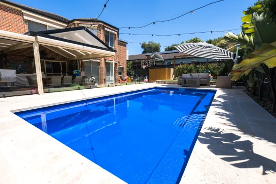 Blue backyard fibreglass pool